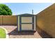 Durable backyard storage shed providing ample space for tools and equipment, set against a block wall at 19833 N 47Th Ln, Glendale, AZ 85308
