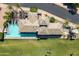 Aerial view of a pool house showing the tile roof, pool, lounge area, and surrounding green space at 2 Biltmore Est # 313, Phoenix, AZ 85016