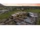Scenic aerial view highlighting the community's homes, lush golf course, and a colorful sunset at 2 Biltmore Est # 313, Phoenix, AZ 85016