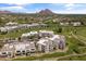 Expansive aerial view showcasing the elegant condo community nestled amidst a lush green golf course with mountain views at 2 Biltmore Est # 313, Phoenix, AZ 85016