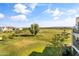 Scenic balcony view of lush golf course, trees, and distant neighborhood at 2 Biltmore Est # 313, Phoenix, AZ 85016