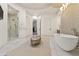 Spa-like bathroom showcasing a soaking tub, walk-in shower, and elegant fixtures at 2 Biltmore Est # 313, Phoenix, AZ 85016