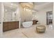 Luxurious bathroom featuring double vanities, a soaking tub, and custom lighting at 2 Biltmore Est # 313, Phoenix, AZ 85016