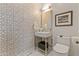 Bathroom featuring a vanity with a square sink, a modern mirror, and patterned wallpaper at 2 Biltmore Est # 313, Phoenix, AZ 85016