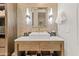 Bathroom vanity with a square sink, a lit mirror, and convenient under-sink basket storage at 2 Biltmore Est # 313, Phoenix, AZ 85016