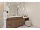 Bathroom vanity with marble countertop, custom wood drawers, and pendant lighting at 2 Biltmore Est # 313, Phoenix, AZ 85016