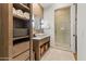 Bright bathroom featuring a glass enclosed shower, stylish vanity, and linen shelving at 2 Biltmore Est # 313, Phoenix, AZ 85016
