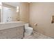 Neutral-toned powder room featuring modern fixtures, marble floors and counter, and textured walls at 2 Biltmore Est # 313, Phoenix, AZ 85016