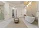 Bright bathroom features a soaking tub, walk-in shower, and modern lighting at 2 Biltmore Est # 313, Phoenix, AZ 85016