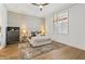 Bedroom features a queen bed, stylish rug, wooden floors, and custom window shutters at 2 Biltmore Est # 313, Phoenix, AZ 85016