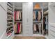 Custom walk-in closet with white built-ins, shoe shelves, and hanging space at 2 Biltmore Est # 313, Phoenix, AZ 85016