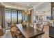 Open dining area with outdoor views, chandelier lighting, and floral upholstered chairs at 2 Biltmore Est # 313, Phoenix, AZ 85016
