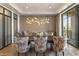 Elegant dining room with stylish chandelier and floral chairs with view to back yard at 2 Biltmore Est # 313, Phoenix, AZ 85016
