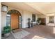 Inviting front entrance with arched doorway, covered walkway, and stylish decor creating a welcoming curb appeal at 2 Biltmore Est # 313, Phoenix, AZ 85016