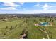 Picturesque aerial view of a well-maintained golf course with mature trees, water features, and scenic city skyline in the distance at 2 Biltmore Est # 313, Phoenix, AZ 85016