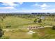 Aerial shot displaying a sprawling golf course with practice facilities, a serene pond, and cityscape horizons at 2 Biltmore Est # 313, Phoenix, AZ 85016