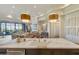 Bright, open kitchen featuring marble counters, large island, and pendant lighting and view to living room at 2 Biltmore Est # 313, Phoenix, AZ 85016