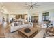 Open-concept living room featuring high ceilings, modern fan, and seamless flow to kitchen and dining areas at 2 Biltmore Est # 313, Phoenix, AZ 85016