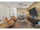 Inviting living room with plush seating, modern ceiling fan and stylish entertainment center at 2 Biltmore Est # 313, Phoenix, AZ 85016