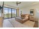 Bright main bedroom featuring large windows, a ceiling fan, and luxurious textures at 2 Biltmore Est # 313, Phoenix, AZ 85016