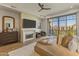 Serene main bedroom with fireplace, balcony access, and picturesque views at 2 Biltmore Est # 313, Phoenix, AZ 85016