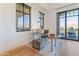 Bright home office with floor to ceiling window, glass desk, and stylish decor at 2 Biltmore Est # 313, Phoenix, AZ 85016