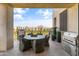 Inviting patio with a dining table, chairs, and outdoor grill with scenic views at 2 Biltmore Est # 313, Phoenix, AZ 85016