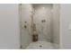 Glass shower with white marble, gold fixtures, and built in niche at 2 Biltmore Est # 313, Phoenix, AZ 85016
