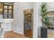 Built-in wine storage unit with glass door, complemented by modern cabinetry and elegant interior design elements at 2 Biltmore Est # 313, Phoenix, AZ 85016