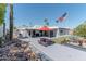 Expansive backyard with an American flag, bbq, artificial turf, and patio area at 2033 E Hillery Dr, Phoenix, AZ 85022