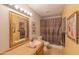 Cozy bathroom featuring warm lighting, neutral vanity, and decorative accents at 2033 E Hillery Dr, Phoenix, AZ 85022