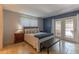 Cozy bedroom featuring a queen bed, matching nightstands, and sliding door access to the patio at 2033 E Hillery Dr, Phoenix, AZ 85022