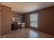 Neutral bedroom space featuring tile floors and a window with natural light at 2033 E Hillery Dr, Phoenix, AZ 85022