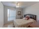 Comfortable bedroom features tile flooring and a ceiling fan at 2033 E Hillery Dr, Phoenix, AZ 85022