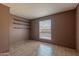 Bedroom features a neutral palette with a single window and built in shelving units at 2033 E Hillery Dr, Phoenix, AZ 85022