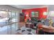 Cozy living room boasts hardwood floors, a gray sofa, and seamless access to the patio at 2033 E Hillery Dr, Phoenix, AZ 85022