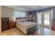 Spacious main bedroom featuring neutral tones, built-in shelves, and access to the outdoors at 2033 E Hillery Dr, Phoenix, AZ 85022