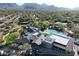 Aerial view of clubhouse with pool, tennis courts, desert landscape, and mountains in background at 20704 N 90Th Pl # 1015, Scottsdale, AZ 85255