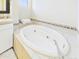 Soaking tub with decorative tile surround and white cabinets at 20704 N 90Th Pl # 1015, Scottsdale, AZ 85255
