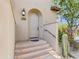 Charming front door with stucco exterior and a cactus garden, creating a welcoming desert oasis entrance at 20704 N 90Th Pl # 1015, Scottsdale, AZ 85255