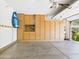 Well-organized garage with storage cabinets and workspace featuring an epoxy floor and access to a desert landscaped backyard at 20704 N 90Th Pl # 1015, Scottsdale, AZ 85255