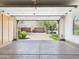 Clean garage with epoxy floors and storage, with a view to the driveway and garages across the street at 20704 N 90Th Pl # 1015, Scottsdale, AZ 85255