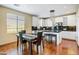 Charming eat-in kitchen with white cabinetry, granite countertops, stainless appliances, and view to dining area at 20704 N 90Th Pl # 1015, Scottsdale, AZ 85255