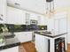 Stylish kitchen boasts white cabinets, stainless steel appliances, granite counters, and an island with seating at 20704 N 90Th Pl # 1015, Scottsdale, AZ 85255