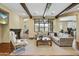 Cozy living room with hardwood floors, a fireplace, exposed beams, and a large window for natural light at 20704 N 90Th Pl # 1015, Scottsdale, AZ 85255