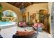 Well-lit living room with wicker furniture and a view of the pool at 20704 N 90Th Pl # 1015, Scottsdale, AZ 85255