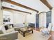 Bright living room with exposed beams, open floor plan, wood floors, and great natural light at 20704 N 90Th Pl # 1015, Scottsdale, AZ 85255
