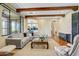 Open living room showcasing hardwood floors, exposed beams, and seamless access to the kitchen at 20704 N 90Th Pl # 1015, Scottsdale, AZ 85255