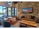 Comfortable lounge area featuring a stone wall, plush seating, and scenic outdoor views at 20704 N 90Th Pl # 1015, Scottsdale, AZ 85255
