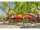 Outdoor dining area with orange umbrellas, tables and chairs at 20704 N 90Th Pl # 1015, Scottsdale, AZ 85255